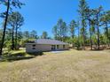 Spacious backyard of the home, ideal for outdoor activities and relaxation at 441 Nw Buena Vista Rd, Dunnellon, FL 34431
