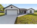 Welcoming single-story home boasting a two-car garage and a freshly maintained lawn at 5 Willow Trl, Ocala, FL 34472