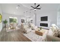 Open-concept living space with a cozy fireplace, tile floors, and bright, airy ambiance at 5 Willow Trl, Ocala, FL 34472