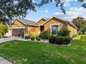 Charming single-story home boasts well-maintained landscaping, a two-car garage, and a cozy front yard at 7432 Sw 98Th Ave, Ocala, FL 34481