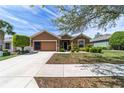 Well maintained one-story home featuring a garage and meticulously landscaped front yard with lush green grass at 7432 Sw 98Th Ave, Ocala, FL 34481