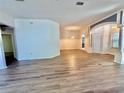 Spacious living room featuring hardwood flooring, arched doorways, and lots of natural light at 8051 Sw 115 Loop, Ocala, FL 34481