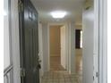 Inviting foyer with neutral tile flooring, fresh paint and easy access to all parts of the home at 8132 Fairways Cir # R103, Ocala, FL 34472