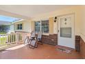 Inviting covered front porch with comfortable seating, perfect for enjoying the outdoors at 8625 Sw 94Th Ln # D, Ocala, FL 34481