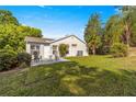 A well-maintained backyard with a patio set, green lawn, and lush landscaping on a sunny day at 8750 Sw 108Th St, Ocala, FL 34481