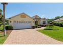Charming single-story home featuring a brick driveway, well-maintained landscaping, and a convenient two-car garage at 8904 Sw 84Th Cir, Ocala, FL 34481