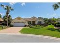 Inviting single-story home with a brick driveway, well-manicured landscaping, and a convenient two-car garage at 8904 Sw 84Th Cir, Ocala, FL 34481