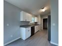 Stylish kitchen with stainless steel appliances, granite counters, and sleek tile flooring at 930 Nw 124Th Pl, Citra, FL 32113