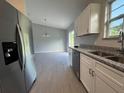 Modern kitchen featuring stainless steel appliances, granite countertops, and white cabinetry at 930 Nw 124Th Pl, Citra, FL 32113