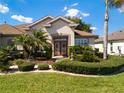 Inviting home featuring mature landscaping and a beautiful front entrance with double glass doors at 9347 Se 137Th Street Rd, Summerfield, FL 34491
