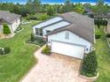 An aerial view of this stunning home with a two-car garage and brick paved driveway at 9740 Sw 68Th Ln, Ocala, FL 34481