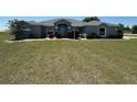 Inviting single story home with a large front yard and a meticulously maintained lawn at 9934 Se 64Th Ave, Belleview, FL 34420
