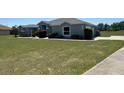 Beautiful single story home featuring manicured lawn and mature shrubbery at 9934 Se 64Th Ave, Belleview, FL 34420