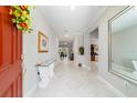 Welcoming foyer with elegant marble floors, a glass table, and views into the living spaces at 10033 Sw 96Th St, Ocala, FL 34481