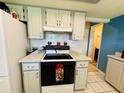 Well-lit kitchen featuring white appliances and white cabinets for storage at 10081 Sw 93Rd Ave, Ocala, FL 34481