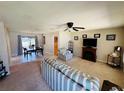 Inviting living room featuring neutral carpet, ceiling fan, and cozy furniture at 10081 Sw 93Rd Ave, Ocala, FL 34481