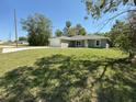 Well-maintained single-story home with a spacious front yard and an attached two-car garage at 10785 Sw 130Th Ct, Dunnellon, FL 34432