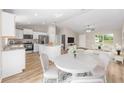 Bright open-concept kitchen featuring an island and stainless appliances connected to the living room at 10869 Sw 140Th Ave, Dunnellon, FL 34432