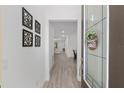 Inviting entryway boasting decorative wall art and a modern front door with a welcoming sign at 1119 Se 42Nd Rd, Ocala, FL 34480