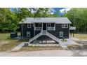 Inviting exterior of a two-story home featuring a staircase and a cozy balcony at 11311 Ne 40Th Street Rd, Silver Springs, FL 34488
