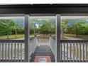 View from front porch looking out onto a large lawn with mature shade trees at 11311 Ne 40Th Street Rd, Silver Springs, FL 34488