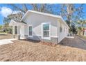 This home has a well-maintained exterior with stone accents and manicured landscaping at 11415 Nw 15Th St, Ocala, FL 34482
