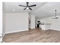 Bright, open-concept living area with modern ceiling fan, hardwood floors, and lots of light at 11415 Nw 15Th St, Ocala, FL 34482