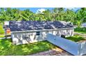 Rear exterior showcasing the home's layout, fresh landscaping, and privacy fence at 11415 Nw 15Th St, Ocala, FL 34482