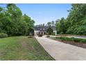 Beautiful home with a lush lawn, mature trees, and long driveway at 1251 Sw 43Rd Pl, Ocala, FL 34471