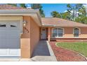 Close up of single story home with mulch landscaping, a lamp fixture, and address number at 13173 Sw 65Th Cir, Ocala, FL 34473