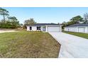 Beautiful single-story home with attached garage and fresh landscaping at 13344 Sw 112 Pl, Dunnellon, FL 34432