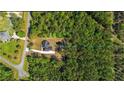 Expansive acreage featuring a beautiful newly constructed home with a long driveway surrounded by lush trees at 14115 Nw 141St Ave, Williston, FL 32696