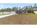 Single Gathering home with a wide driveway, two-car garage, and lush lawn at 15840 Sw 38 Pl, Ocala, FL 34481