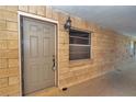 Condo front entrance with a secure door, brick facade, and a charming outdoor light fixture at 2837 Ne 3Rd St # 103, Ocala, FL 34470