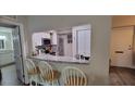 Breakfast bar with granite counters overlooks kitchen with stainless steel appliances at 2843 Ne 3Rd St # 109, Ocala, FL 34470