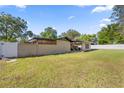 Spacious backyard with green lawn and partial fencing offers privacy and a pleasant outdoor space at 4410 Ne 13Th St, Ocala, FL 34470