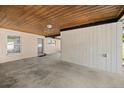 Covered carport area with concrete flooring provides shelter and access to the home's entrance at 4410 Ne 13Th St, Ocala, FL 34470