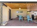 Cozy front porch with brick flooring features outdoor seating and decorative string lights, inviting relaxation at 4410 Ne 13Th St, Ocala, FL 34470