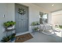 Cozy front porch featuring a 'Welcome' mat, decorative wreath, and comfortable rocking chairs at 4806 Sw 86Th Ln, Ocala, FL 34476