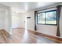 Bright living room with wood floors, a large window, and neutral paint at 7787 Nw 56Th Pl, Ocala, FL 34482