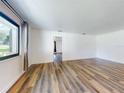 Spacious living room with wood floors, neutral paint, and lots of natural light at 7787 Nw 56Th Pl, Ocala, FL 34482
