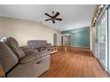 Comfortable living room with a ceiling fan and sliding glass doors at 882 Tanglewood Pl, The Villages, FL 32162