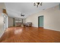 Spacious living room with hardwood floors, fan, and lots of natural light at 882 Tanglewood Pl, The Villages, FL 32162