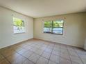 Inviting bedroom with tile flooring, bright walls and two windows at 14646 Sw 43Rd Court Rd, Ocala, FL 34473
