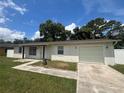 Well-maintained single-story home with a lush green lawn and a paved driveway at 14646 Sw 43Rd Court Rd, Ocala, FL 34473