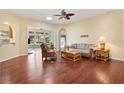 Spacious living room boasts hardwood floors, a ceiling fan, and an open layout at 17536 Se 119Th Cir, Summerfield, FL 34491