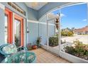 Cozy screened-in porch features comfortable seating and a view of the landscaped front yard at 17536 Se 119Th Cir, Summerfield, FL 34491