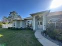 Inviting home exterior with large arch windows and a covered front entrance featuring a white chair at 1961 Sw 170Th Loop, Ocala, FL 34473