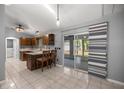 Modern kitchen with granite countertops, wood cabinets, island with seating, and stainless steel appliances at 2199 Se 175Th Ter, Silver Springs, FL 34488