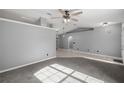 Spacious living room featuring carpet flooring, neutral paint, ceiling fan, and recessed lighting at 2199 Se 175Th Ter, Silver Springs, FL 34488